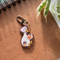 Cozy goose reading Acrylic Keychain