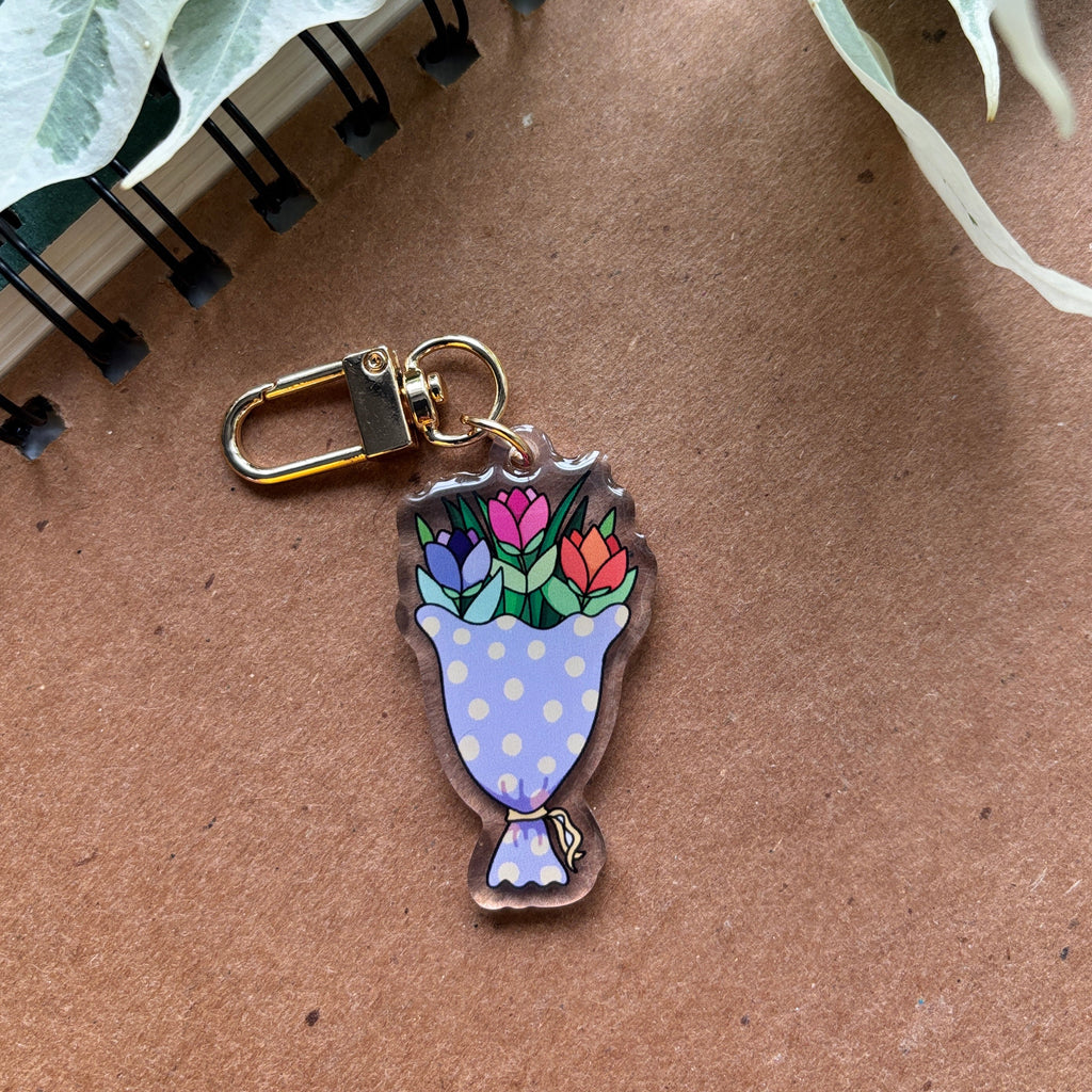 Keychain with floral design on a brown surface
