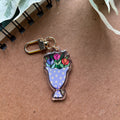 Keychain with floral design on a brown surface