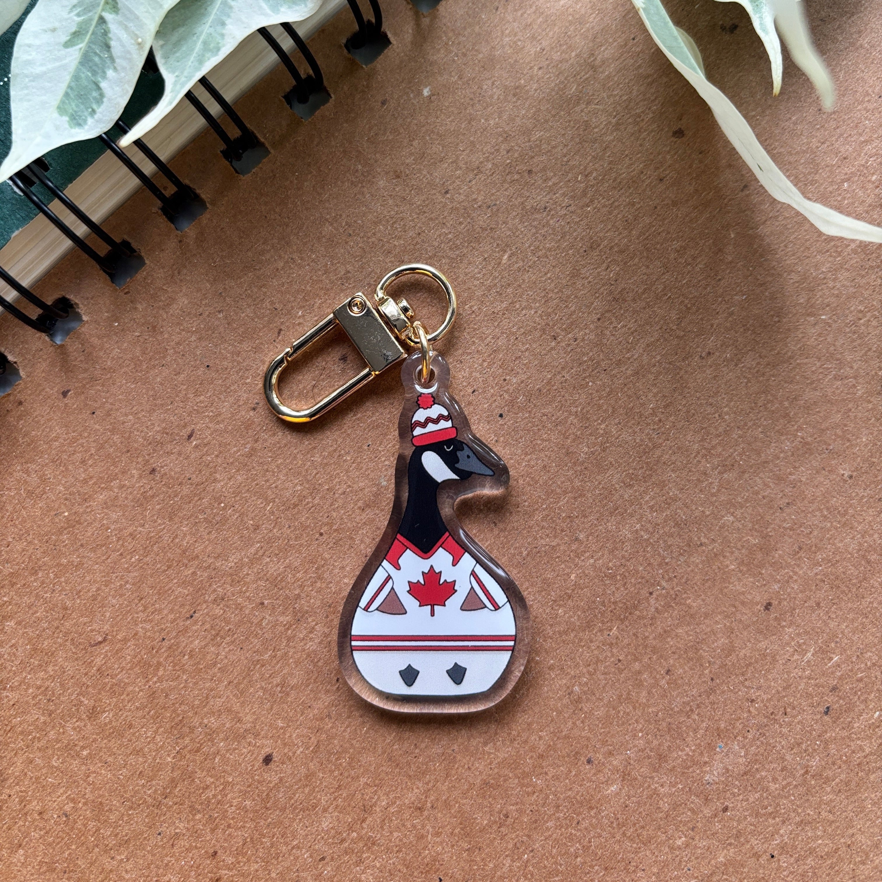 Keychain of a Canadian Goose wearing a hockey jersey